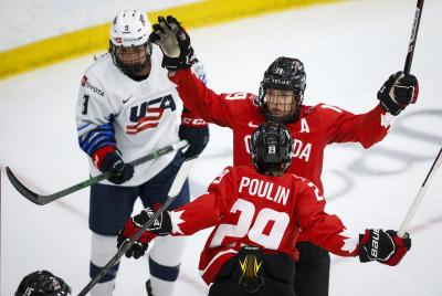 Canada's Brianne Jenner, right, celebrates her goal with teammate Marie-Philip Poulin, centre, during the second period of the gold medal final IIHF Women's World Championship hockey action in Calgary on Aug. 31, 2021.(THE CANADIAN PRESS/Jeff McIntosh)