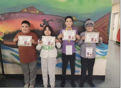 From left to right, Mistissini Voyageur Memorial Elementary Grade 5 students Angel MacLeod, Serena Shecapio, Lucas Trapper and Lennox Swallow hold up their first-place certificates from the regional science fair. (Voyageur Memorial Elementary/Facebook)