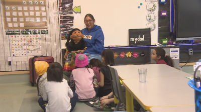 Theresa O'Watch teaches a Nakoda language class with the help of Kushi, a puppet gifted to her by a friend. (Richard Agecoutay/CBC)