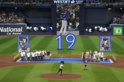 Former Toronto Blue Jays player Jose Bautista throws the ceremonial first pitch after his name was unveiled on the Jays' Level of Excellence, ahead of their MLB interleague baseball game against the Chicago Cubs, in Toronto on August 12, 2023. (THE CANADIAN PRESS/Chris Young) 