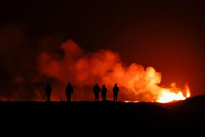People watch as a volcano erupts in southwest Iceland. (Photo via Getty Images’ Facebook page.) People watch as a volcano erupts in southwest Iceland. (Photo via Getty Images’ Facebook page.)