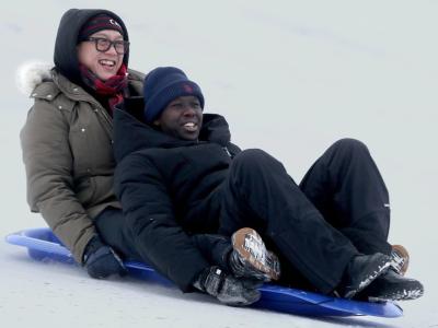 Dave Nguyen and Chance Niyomugabo enjoy a toboggan ride together. (Photo via The Valley Spreader’s Facebook page.)