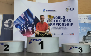 Shawn Rodrigue-Lemieux is pictured with his trophy after beating out players from 54 countries at the world under-18 chess championships in Romania.