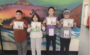 From left to right, Mistissini Voyageur Memorial Elementary Grade 5 students Angel MacLeod, Serena Shecapio, Lucas Trapper and Lennox Swallow hold up their first-place certificates from the regional science fair. (Voyageur Memorial Elementary/Facebook)
