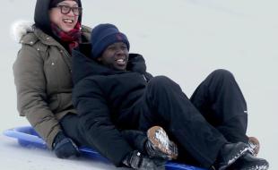 Dave Nguyen and Chance Niyomugabo enjoy a toboggan ride together. (Photo via The Valley Spreader’s Facebook page.)